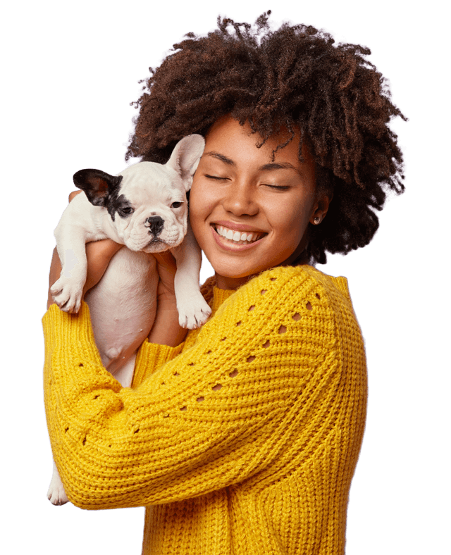 Smiling pet owner with French Bulldog puppy